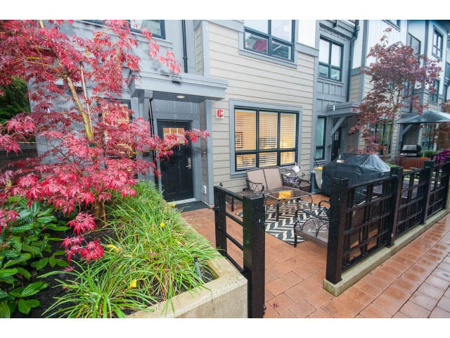 Furnished patio with red maple tree, brick flooring, and outdoor seating. - 9 - 3508 Mount Seymour Pkwy, North Vancouver