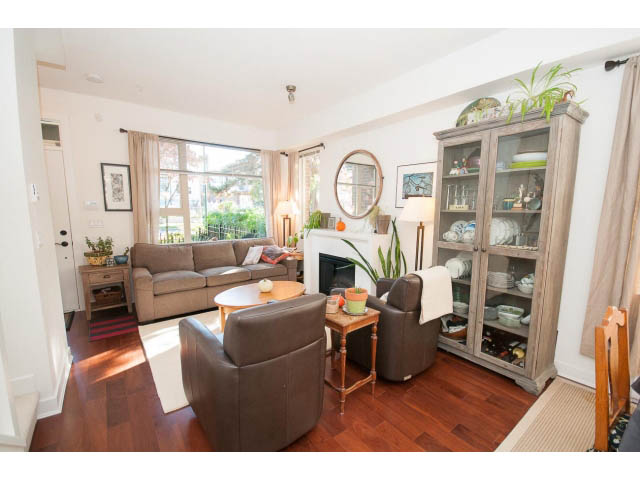 Spacious living room with hardwood floors, large windows, and a cozy corner setup. - 4539 Prince Albert Street, Vancouver East Side