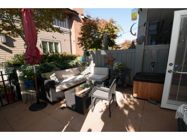Furnished patio with outdoor seating, wooden fence, and potted plants. - 4539 Prince Albert Street, Vancouver East Side