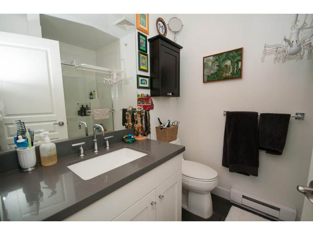Bathroom with dark countertops, white cabinets, and a toilet. - 4539 Prince Albert Street, Vancouver East Side