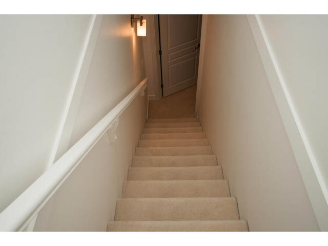 Staircase leading to upper level with carpeted steps and white walls. - 4539 Prince Albert Street, Vancouver East Side