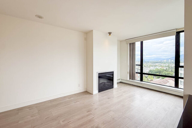 Bright living room with light wood floors and panoramic city view. - 1605 - 151 West 2nd Street, North Vancouver