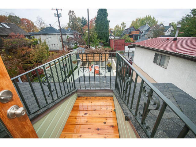 Furnished balcony with wooden flooring and metal railings, overlooking a neighborhood. - Upper - 817 Union St, Vancouver East Side