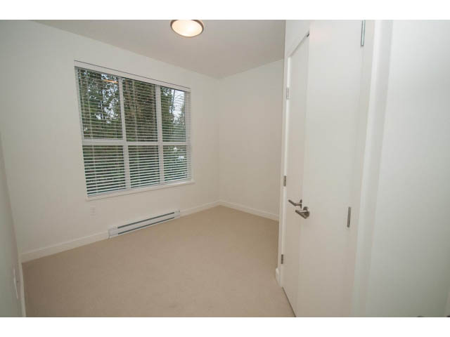 Den area with carpeted floor and large window, natural light. - 410 - 3205 Mountain Hwy, North Vancouver