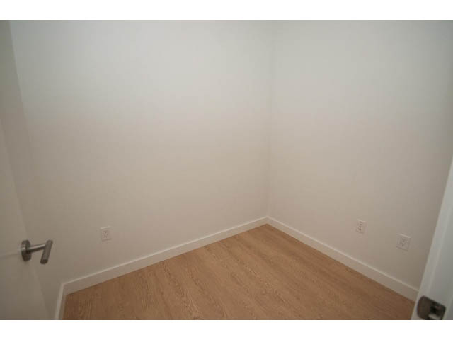 Den with hardwood floors and white walls. - 410 - 3205 Mountain Hwy, North Vancouver