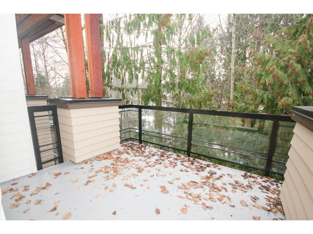 Furnished balcony with snowy ground and evergreen trees, 2-bedroom + den condo. - 410 - 3205 Mountain Hwy, North Vancouver
