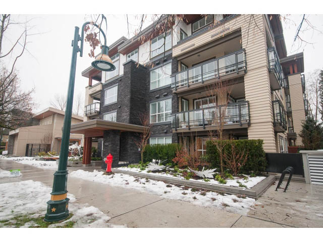 Furnished 2-bedroom + den condo with modern balcony and snow-covered landscape. - 410 - 3205 Mountain Hwy, North Vancouver