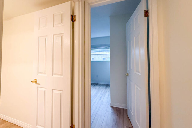 Hallway doorway into the upper bedroom, window with a shade, hardwood floors. - 13-870 West 7th Avenue, Vancouver West Side