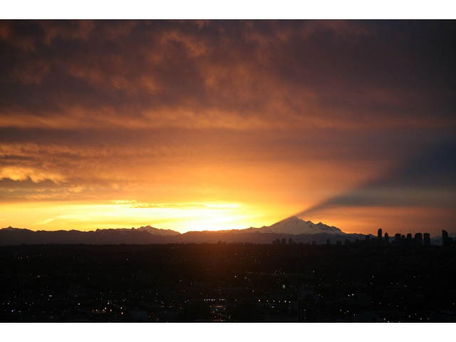 Furnished living room with a stunning city view at sunset. - 4609 - 777 Richards St, Vancouver Downtown