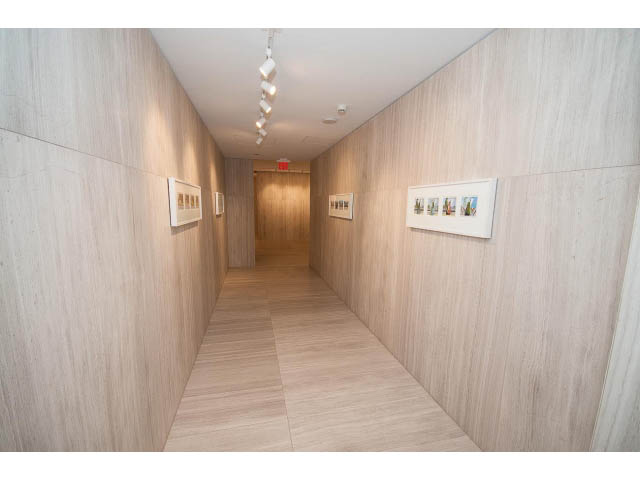 Bright hallway with light wood walls and ceiling, leading to another room. - 4609 - 777 Richards St, Vancouver Downtown