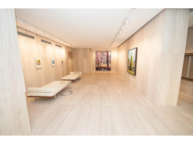 Furnished living room with modern decor, light wood walls and floors, and wall-mounted artwork. - 4609 - 777 Richards St, Vancouver Downtown