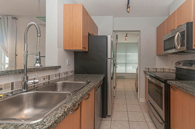 Bright kitchen with granite countertops, stainless steel appliances, and city view. - 1506 - 1420 West Georgia Street, Vancouver Downtown