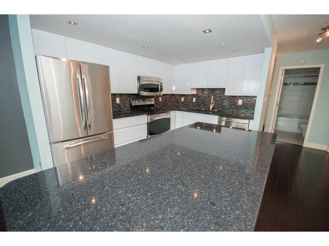 Bright kitchen with granite countertops, stainless steel appliances, and hardwood floors. - 706 - 1088 Quebec St., Vancouver East Side