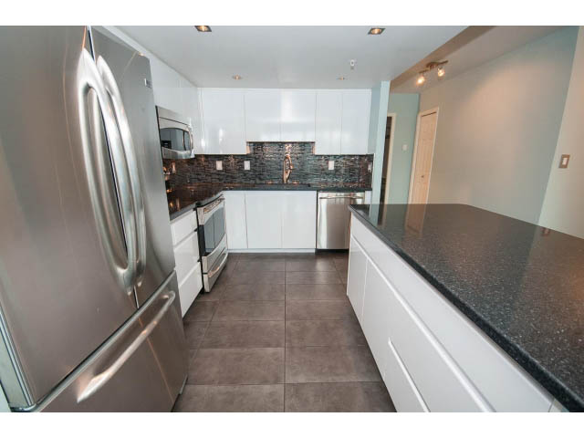 Bright kitchen with granite countertops and white cabinetry, modern design. - 706 - 1088 Quebec St., Vancouver East Side
