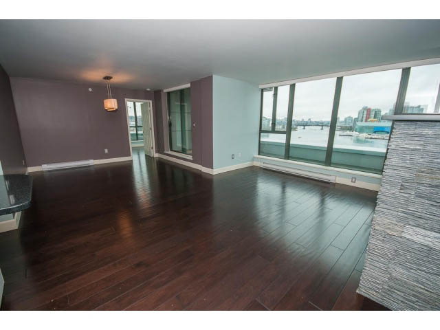 Spacious living room with hardwood floors, city view, and modern decor. - 706 - 1088 Quebec St., Vancouver East Side