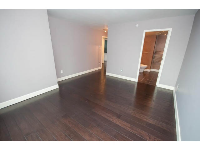 Spacious living room with hardwood floors and neutral walls. - 706 - 1088 Quebec St., Vancouver East Side
