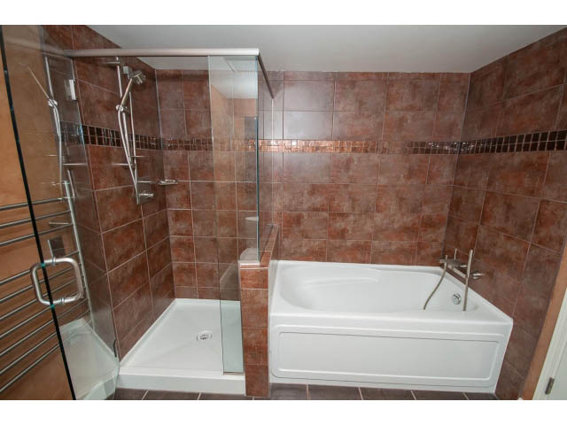 Furnished bathroom with glass shower and bathtub, modern tile design. - 706 - 1088 Quebec St., Vancouver East Side