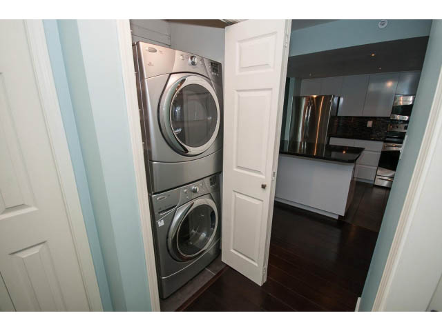 Bright laundry room with stainless steel appliances and hardwood floors. - 706 - 1088 Quebec St., Vancouver East Side