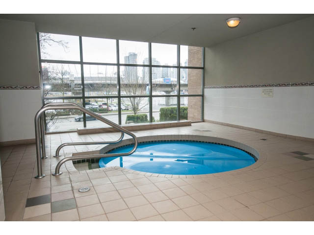 Spacious living room with large windows, city view, and tiled floors. - 706 - 1088 Quebec St., Vancouver East Side