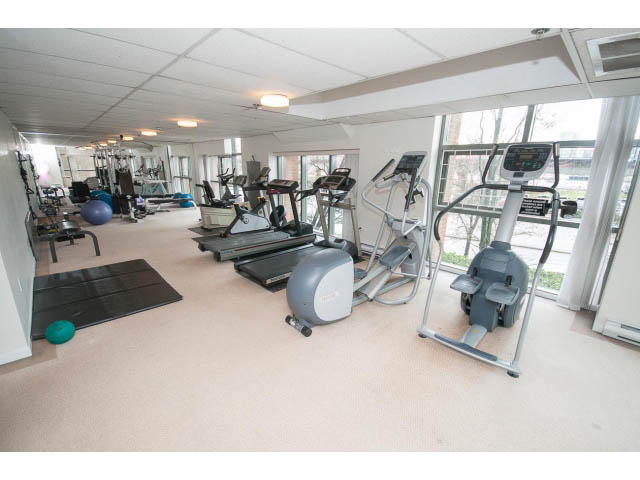 Spacious gym with cardio equipment and large windows. - 706 - 1088 Quebec St., Vancouver East Side