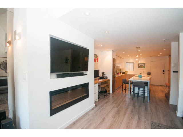 Spacious living room with hardwood floors and a modern fireplace. - 15 - 2151 Banbury Rd, North Vancouver