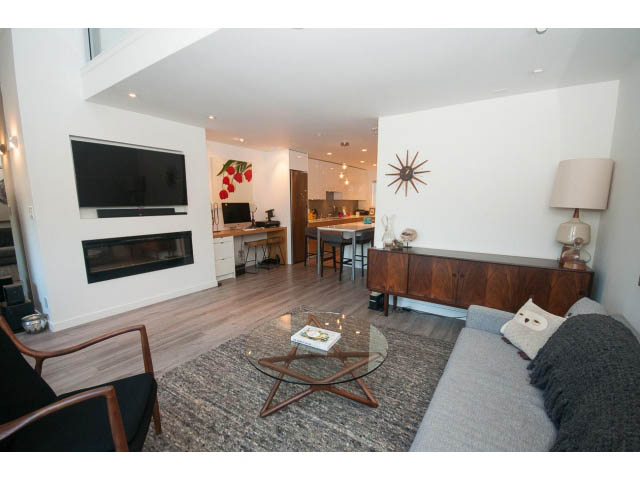 Spacious living room with hardwood floors, modern furniture, and a flat-screen TV. - 15 - 2151 Banbury Rd, North Vancouver