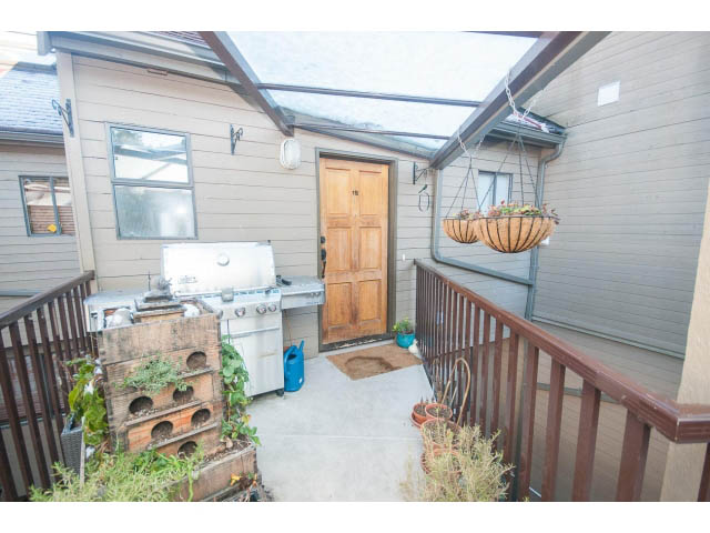 Furnished patio with wooden railings, hanging basket, and outdoor grill. - 15 - 2151 Banbury Rd, North Vancouver