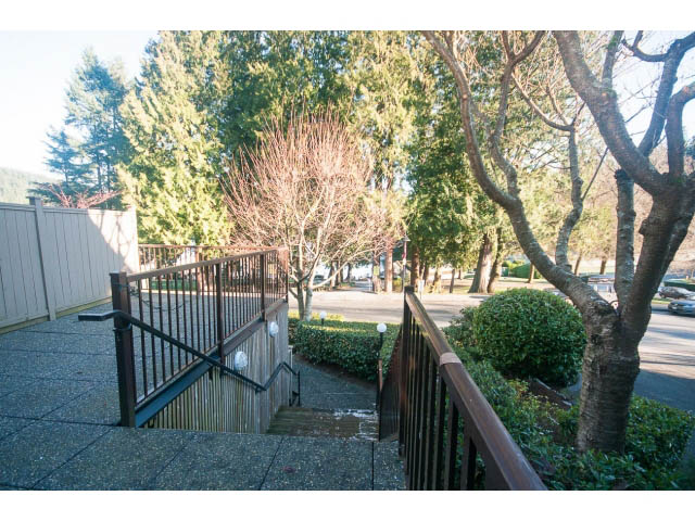 Furnished patio with wooden railings and lush greenery. - 15 - 2151 Banbury Rd, North Vancouver