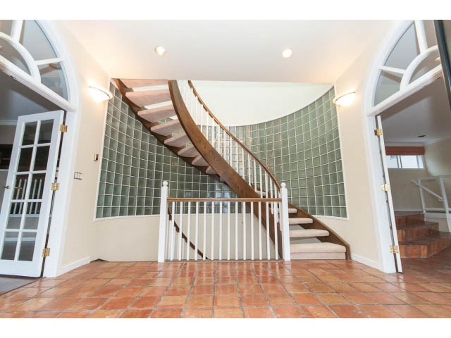 Staircase with glass tile wall and terracotta flooring. - 4220 Starlight Way, North Vancouver