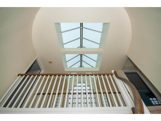 Bright staircase with skylight and modern railings. - 4220 Starlight Way, North Vancouver