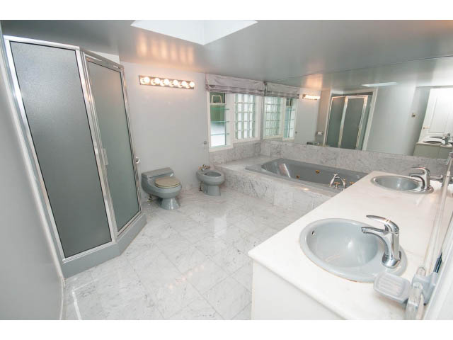 Spacious bathroom with marble countertops and a large vanity sink. - 4220 Starlight Way, North Vancouver