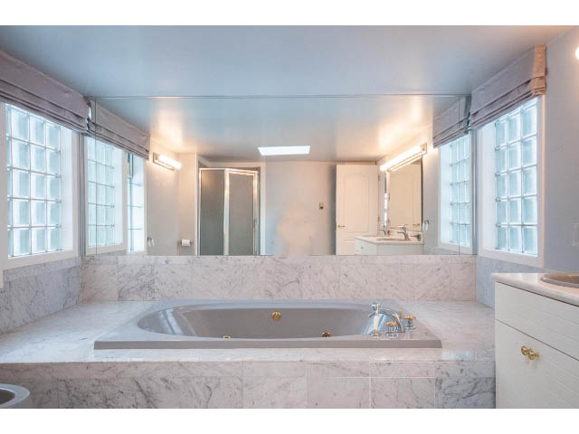 Bright bathroom with marble countertops and large windows. - 4220 Starlight Way, North Vancouver
