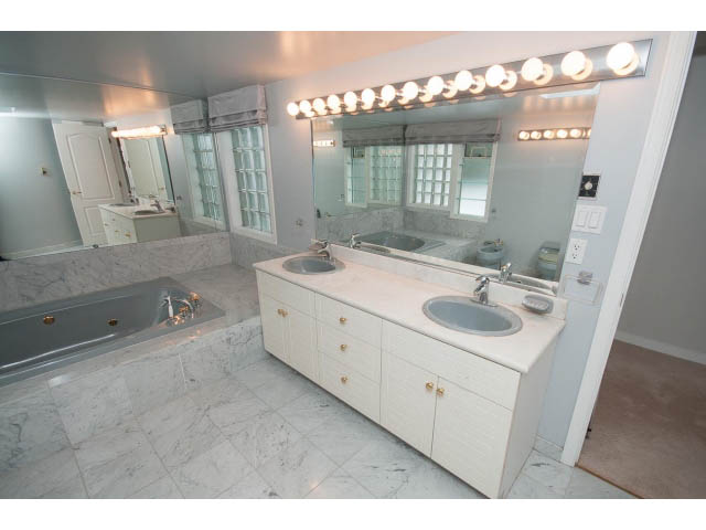 Spacious bathroom with marble countertops and a large vanity sink. - 4220 Starlight Way, North Vancouver