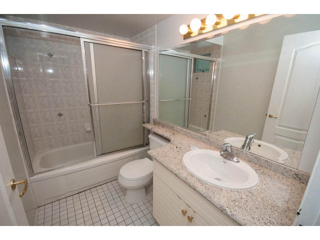 Bright bathroom with granite countertops and a walk-in shower. - 4220 Starlight Way, North Vancouver