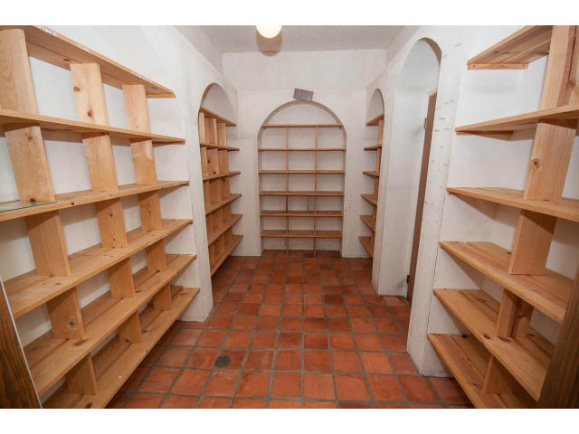 Framed staircase with wooden shelves and terracotta tile floor. - 4220 Starlight Way, North Vancouver