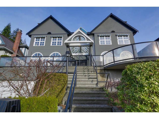 Furnished 4-bedroom house with dark exterior, large arched windows, and stone steps leading up to the entrance. - 4220 Starlight Way, North Vancouver