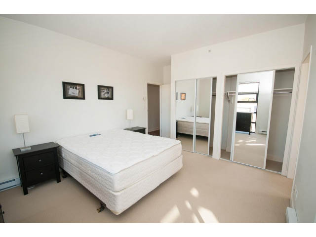 Bright bedroom with white furniture, large closet, and natural light. - 401 - 2828 Yew St, Vancouver West Side