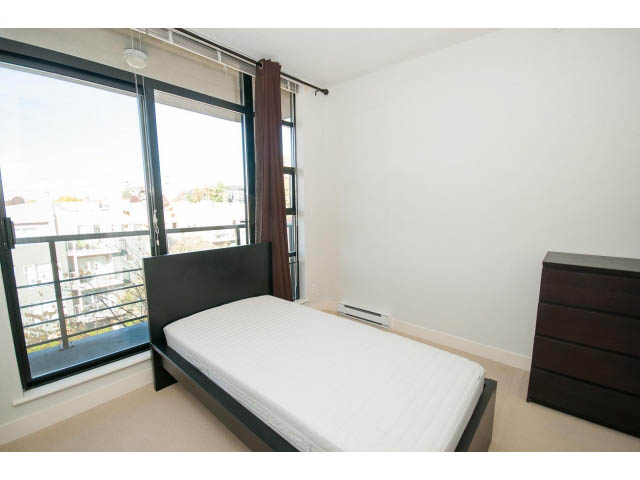 Bright bedroom with large window, city view, and modern furniture. - 401 - 2828 Yew St, Vancouver West Side
