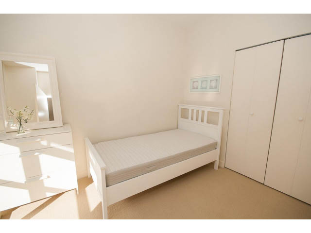 Bright bedroom with white furniture, large closet, and natural light. - 401 - 2828 Yew St, Vancouver West Side