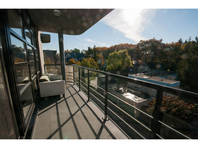 Furnished balcony with glass railings and city view. - 401 - 2828 Yew St, Vancouver West Side