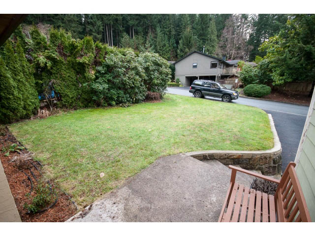 Furnished living room with cozy seating and a view of the forest. - 2346 Riverbank Place, North Vancouver