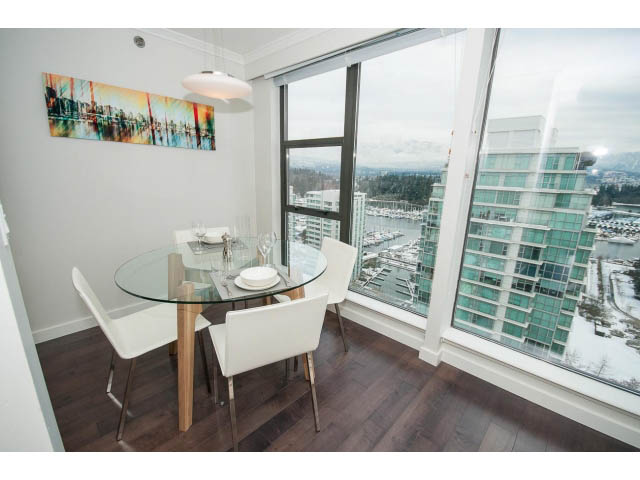 Furnished dining area with hardwood floors, city view, and modern decor. - 2407 - 1723 Alberni, Vancouver Downtown