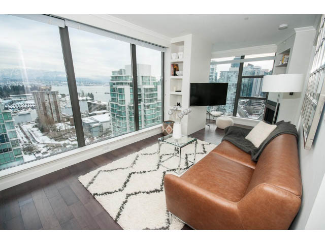 Furnished living room with large windows, hardwood floors, and a city view. - 2407 - 1723 Alberni, Vancouver Downtown