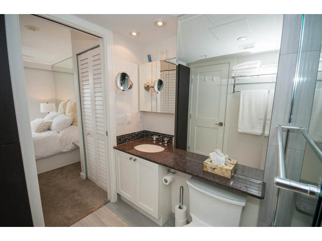 Furnished bathroom with granite countertops and a large mirror. - 2407 - 1723 Alberni, Vancouver Downtown