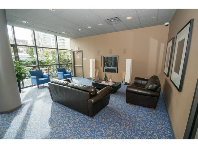 Furnished living room with blue carpet, city view, and modern furniture. - 2407 - 1723 Alberni, Vancouver Downtown