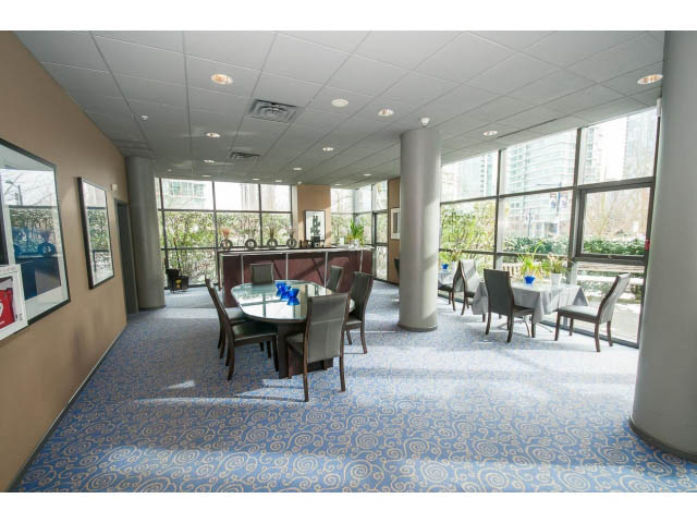 Furnished dining area with large windows, city view, and patterned carpet. - 2407 - 1723 Alberni, Vancouver Downtown