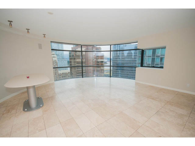 Bright living room with large windows, city view, and modern furnishings. - 1902 - 838 W Hastings, Vancouver Downtown