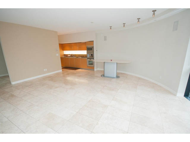 Open-concept living area with modern kitchen and tiled flooring. - 1902 - 838 W Hastings, Vancouver Downtown
