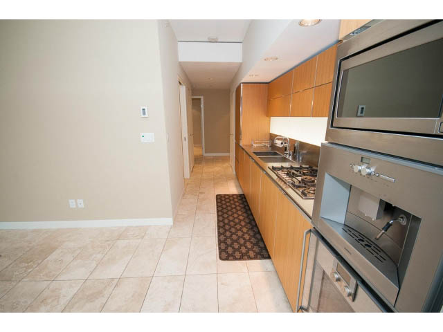 Bright kitchen with modern appliances, granite countertops, and a tiled backsplash. - 1902 - 838 W Hastings, Vancouver Downtown