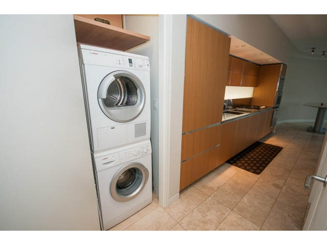 Bright laundry room with modern appliances and wooden cabinets. - 1902 - 838 W Hastings, Vancouver Downtown
